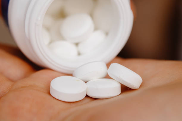 istock Hands full of pills pills in a bottle 1468143499
