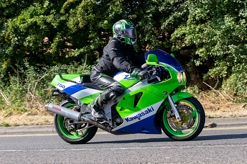 Potterspury,Northants, UK - August 14th 2022. Man riding a classic 1990 Kawasaki ZXR 750 motorcycle on an English country road