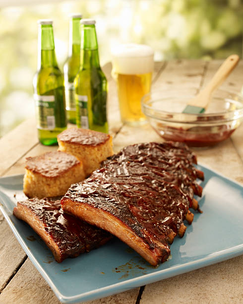 Ribs on a platter with beer in the background stock photo