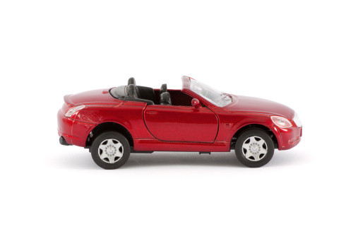 A red toy car representing a convertible sports car.