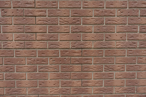Backdrop - chocolate brown brick veneer wall with grey mortar joints