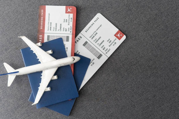 istock Plane tickets, passports and toy plane on table 1468145666