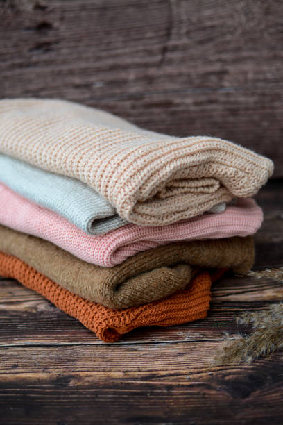istock The pile of knitted sweaters on dark brown background 1468146100