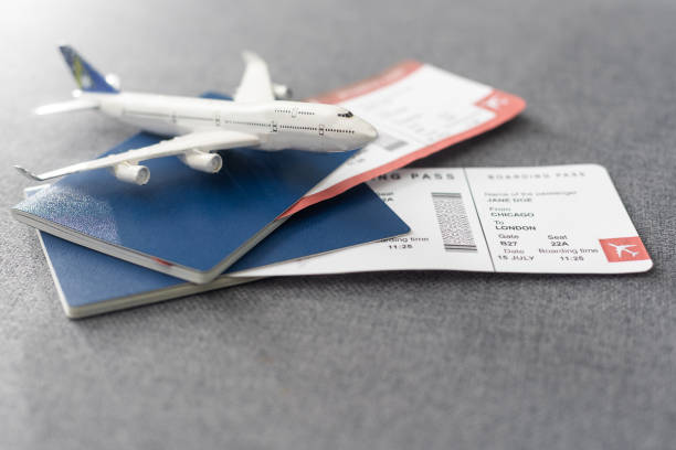 istock Passports, boarding passes and toy airplane on gray table 1468146139