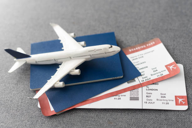istock Passports, boarding passes and toy airplane on gray table 1468147472