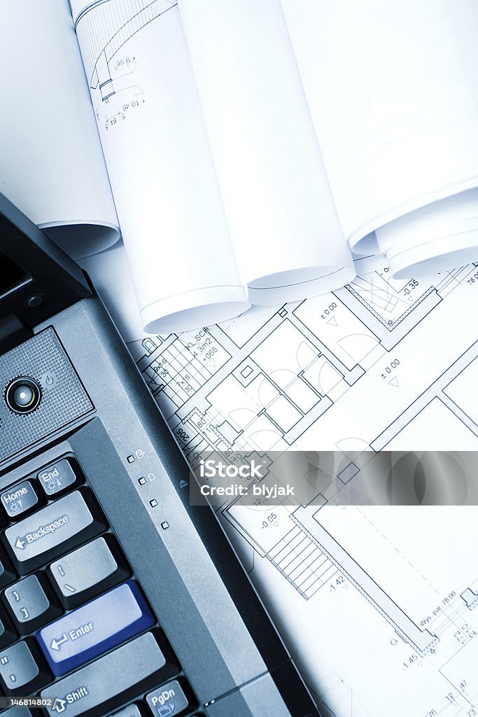 Blueprints and laptop series... House blueprints, laptop and rolled plans. Backgrounds Stock Photo