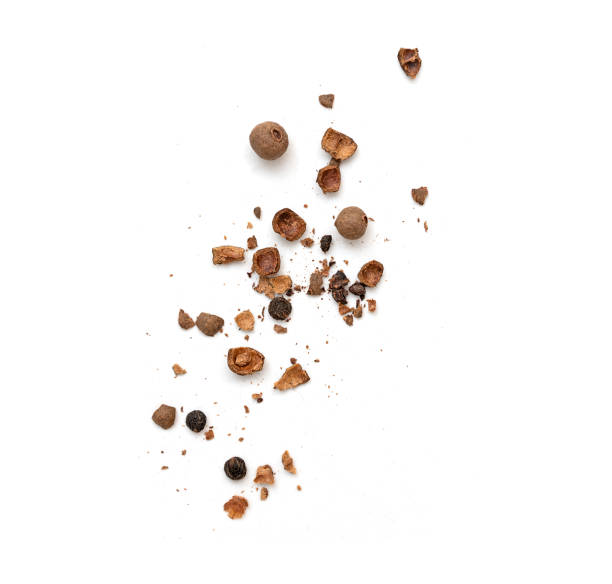 istock Whole and broken allspice pieces falling and isolated on white, top view 1468150170