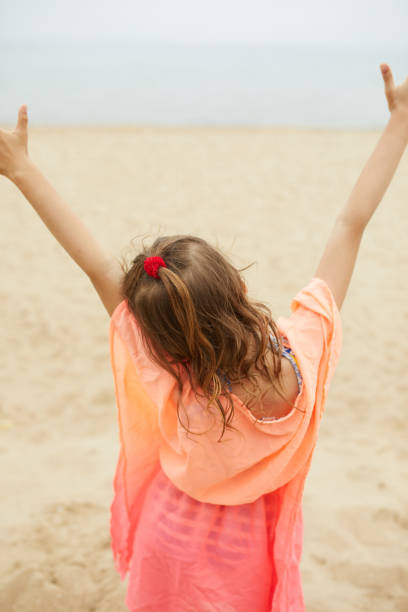 istock Happy, joyful little girl run on the beach 1468150497