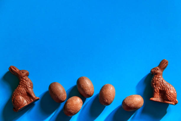 istock Easter chocolate bunnies and chocolate eggs on blue background. Top view 1468152503
