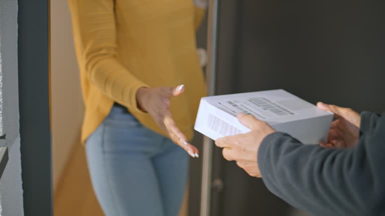 Woman receiving a package delivered to her front door