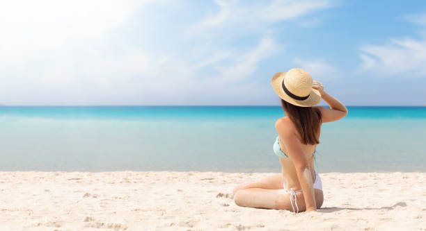 istock Woman sitting on the sea beach 1468154426