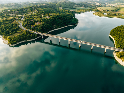 Aerial view of a bridge over a lake in Tuscany. Bilancino lake in Tuscany.