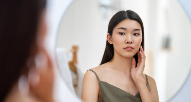 istock woman looking at mirror 1468156461