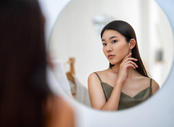 istock woman looking at mirror 1468156525