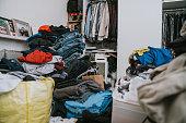 A messy bedroom during the change of wardrobe