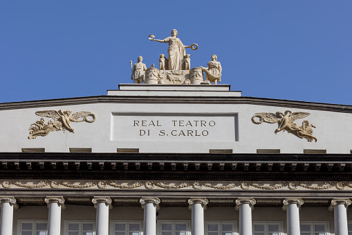 Naples, Italy - June 27, 2021: Facade of 18th century Royal Theatre of Saint Charles (Teatro di San Carlo), top floor. It is the oldest continuously active venue for opera in the world, having opened in 1737