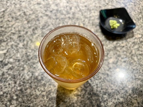 a Glass of Cold Ocha or Green Tea With Ice on The Top of Table
