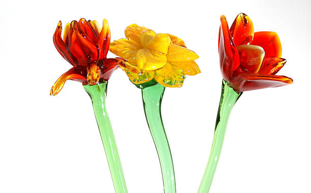 Flowers of colored glass (souvenir) closeup isolated on white