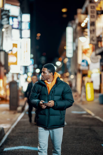 istock Mid adult man exploring Japanese night life 1468160436