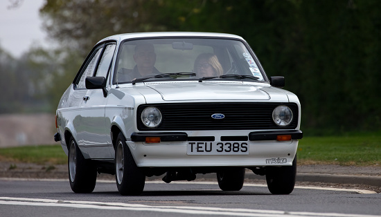 Bicester, Oxon., UK - April 24th 2022. 1978 white Ford Escort Mexico travelling on an English country road