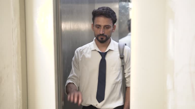 Sad business employee with depression stand inside lift at office building