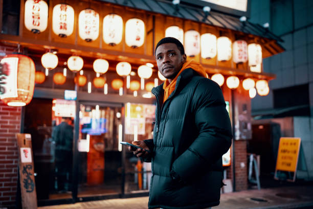 istock Mid adult man exploring Japanese night life 1468162507