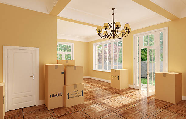 Empty room full of cardboard boxes from moving stock photo