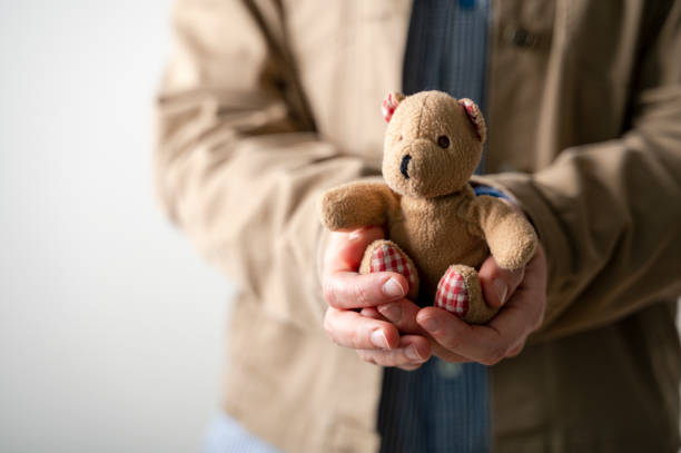 istock Person holding bear toy in hands 1468164513