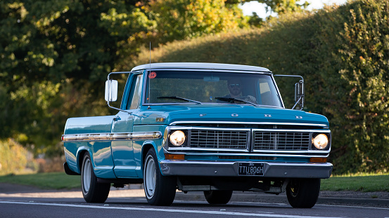 Stony Stratford, Bucks, UK, Jan 1st 2023. 1970 blue Ford F100 pick up truck driving on an English country road