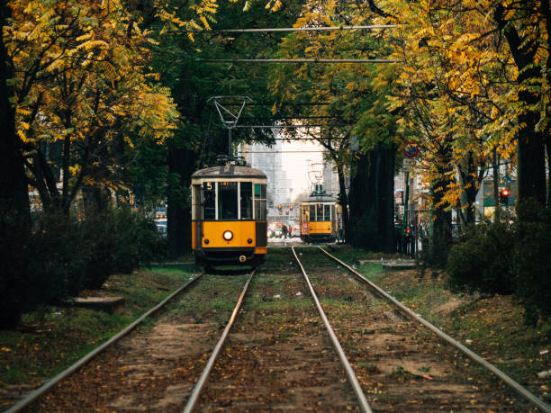 old yellow trams in milan, italy - blurred motion street car green imagens e fotografias de stock