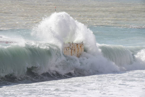 istock A sea wave crashes against an old jetty 1468165979