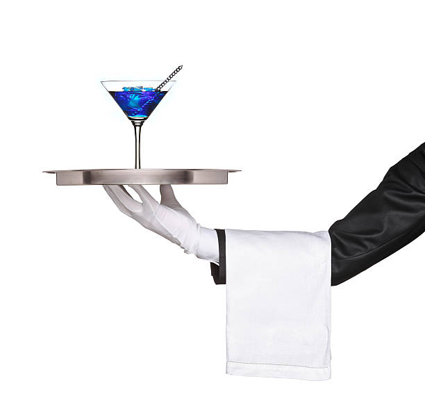 istock Hand holding a silver tray with blue cocktail on it 146816801