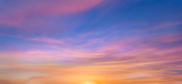 istock Real amazing panoramic sunrise or sunset sky with gentle colorful clouds. Long panorama, crop it. Evening sky scene with golden light from the setting sun 1468168632