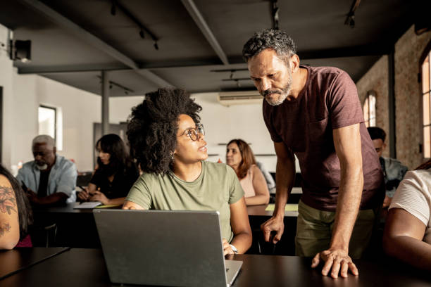 istock Mature man helping student in a classroom 1468168950