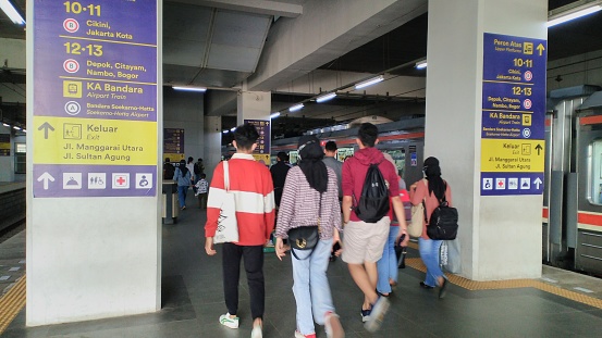 People just get off the electric train on the train platform at Manggarai Station, Jakarta, Indonesia. The photo was taken on October 17, 2022