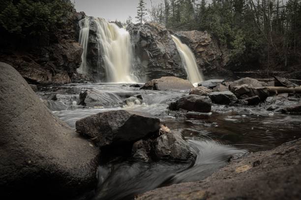 istock Tranquil river flowing through a lush landscape, with overhanging trees and rocky outcrops 1468173902
