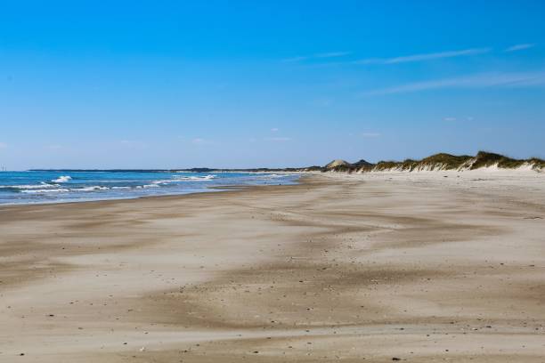 istock Stunning view of an idyllic beach featuring white sand, rolling sand dunes 1468173903