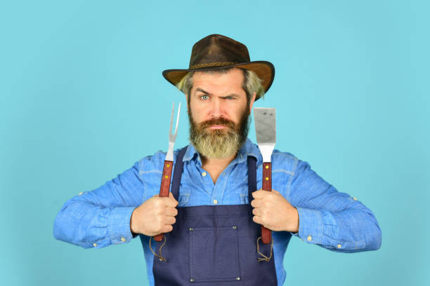 istock camping. Ultimate cooking challenge. prepare dinner for family. use cooking utensils and various products. mature chef use cooking utensils for barbecue. Tools for roasting meat. Who cook better 1468174156