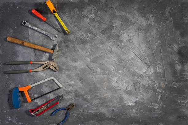 istock Toolkit for work in the home on gray wooden background 1468174914