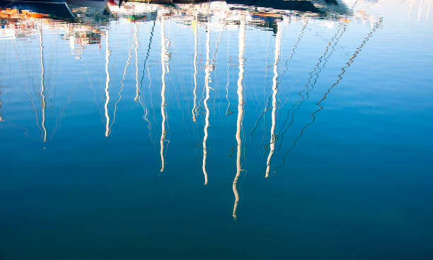 istock Reflection of yacht masts on the sea 1468175638
