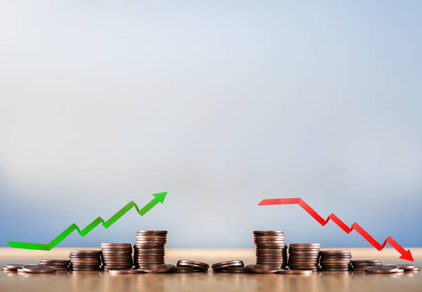 istock Stack coins and arrow red green graph chart volatility up and down on wooden table background. Business, financial and investment concept. Risk, fluctuation in stock market and bitcoin cryptocurrency. 1468177393