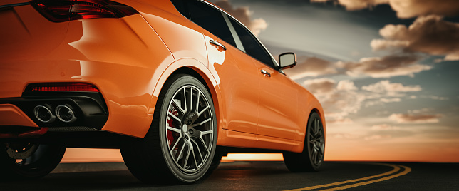 Close-up side view of an orange luxury sports car on the road as the sun sets.3d render and illustration.