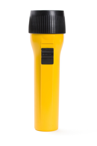Close up of yellow flashlight isolated on white.