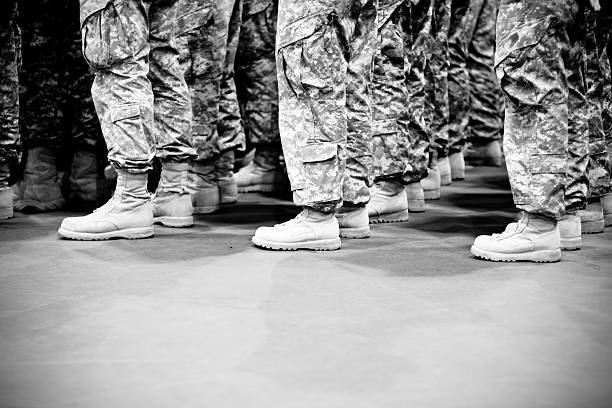 Lines of soldiers standing in formation Camera Canon 40 D, 50 mm 1.4 lens, picture was taken in a gym during re-deployment ceremony, soldiers were standing in formation waiting to be released to their families after returning home from Iraq military deployment photos stock pictures, royalty-free photos & images