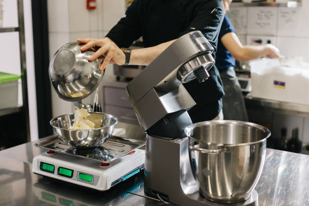 istock Making macarons. A silver kitchen table mixer kneads the dough for macarons. 1468183568
