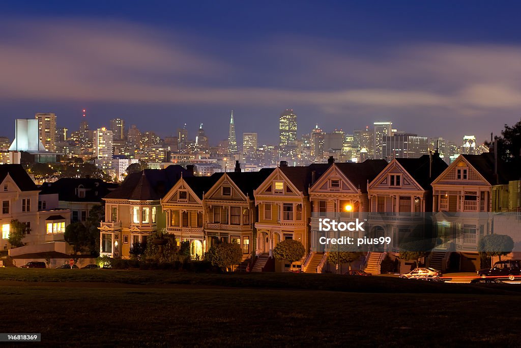 Painted Ladies at Alamo Square Night lays down her garments on the iconic Painted Ladies and downtown San Francisco. House Stock Photo
