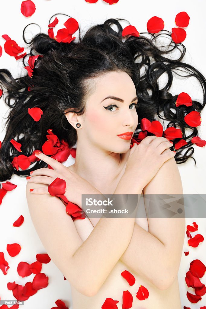 Naked woman covered in red petals beautiful young nude woman with red  rose petals isolated on white Adult Stock Photo