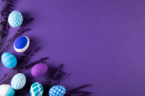 Hand painted colorful easter eggs on purple background