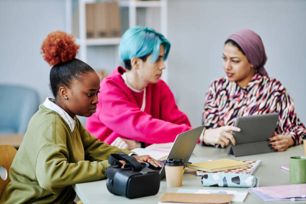 istock Black young woman using laptop during meeting in office 1468187155