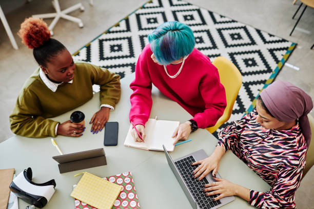 istock Top view at two creative team of three young people brainstorming project 1468187160